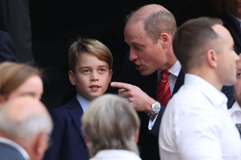 Prince William waving his finger at Prince George.