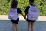 True Thompson and Dream Kardashian twin in matching Aaliyah T-shirts and personalized backpacks